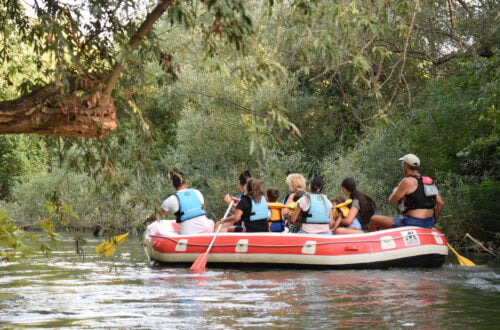 Seven people in a rafting boat in Nestos river