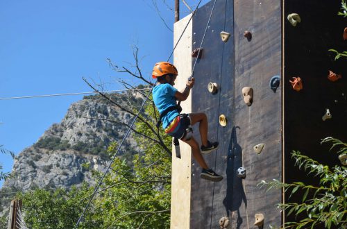 A kid climbing a wall