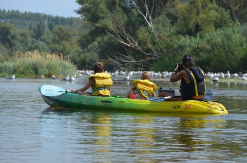 Two kids with an instructor kayaking in Nestos river