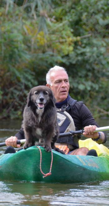 a man with a dog kayaking